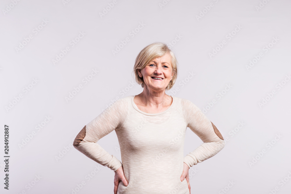 Portrait of a happy senior woman in studio. Portrait of a happy senior woman in studio.