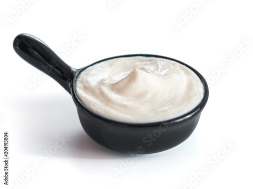 Bowl of sour cream isolated on white background