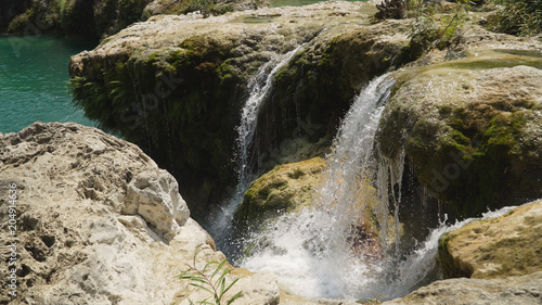 Waterfall in green rainforest. Bolinao waterfall in the mountain jungle. Philippines  Luzon. Travel concept.