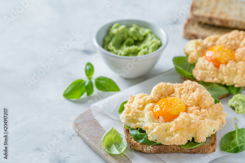 Trendy healthy eating concept - egg clouds on toasts