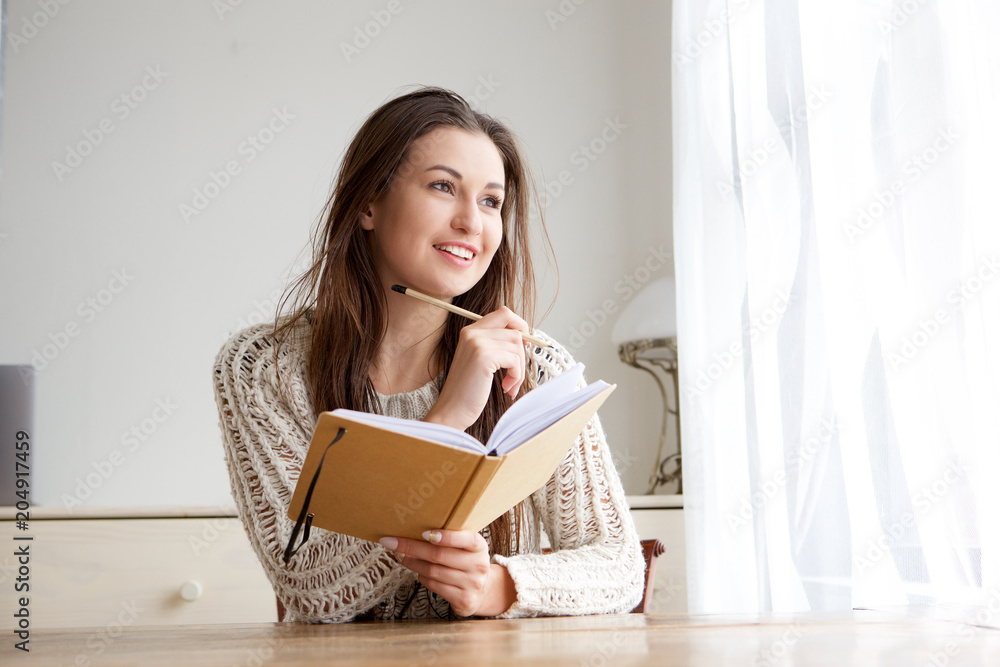 smiling college student with book and pencil smiling college student with book and pencil