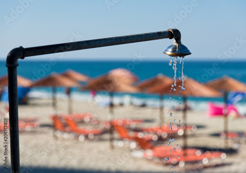 Shower pouring water at the Agios Ioannis beach in the area of Mount Pelion in Greece in summer