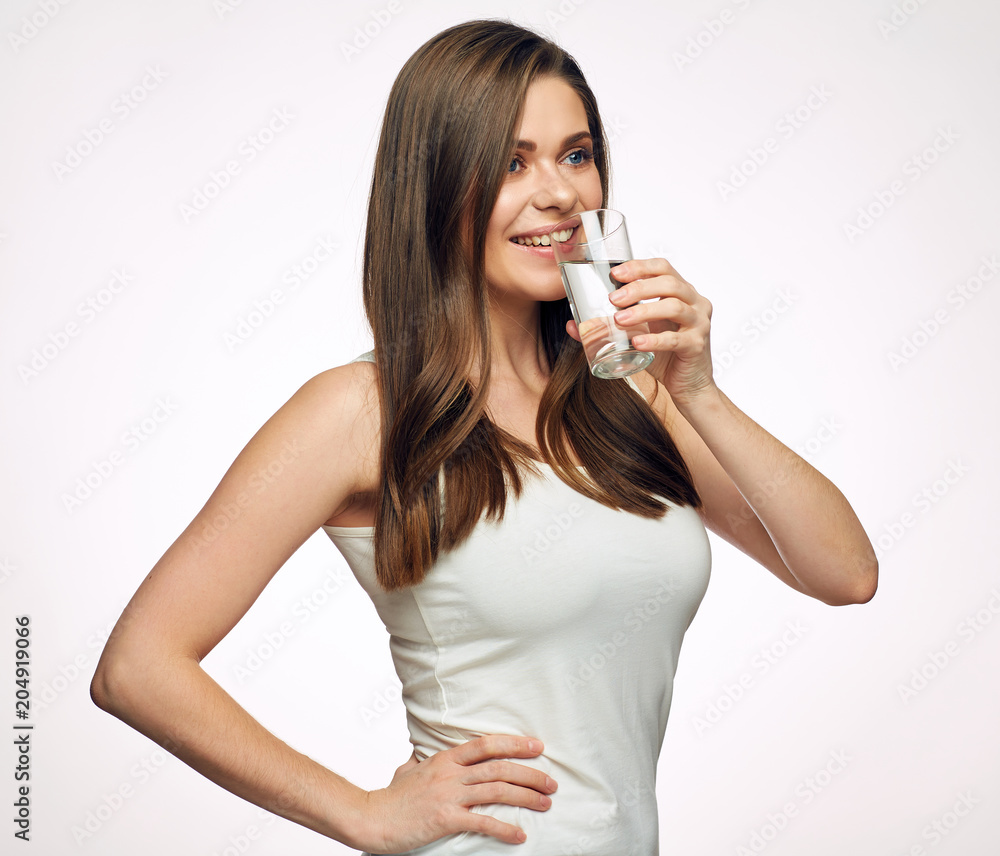 Young smiling woman drinking water from glass. Young smiling woman drinking water from glass.