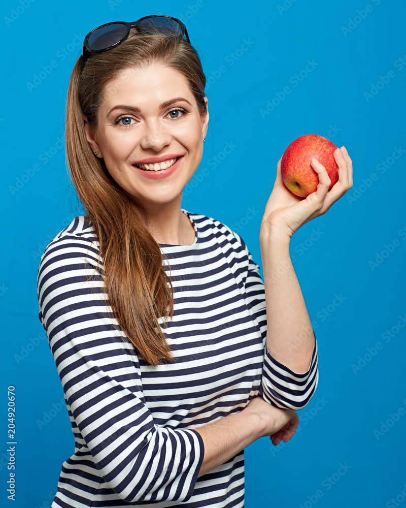 Smiling woman with healthy teeth holding red apple. Smiling woman with healthy teeth holding red apple.