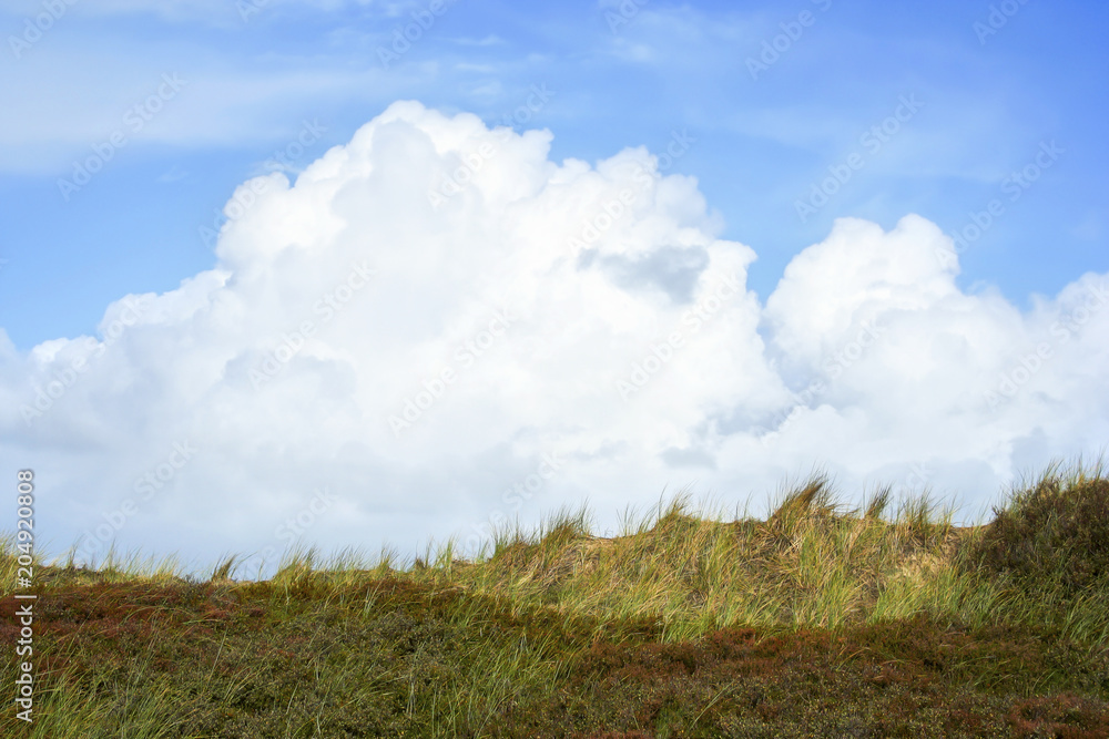 Clouds and dune panorama on the island Clouds and dune panorama on the island