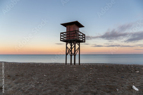 Lifeguard tower on the beach at sunset. 