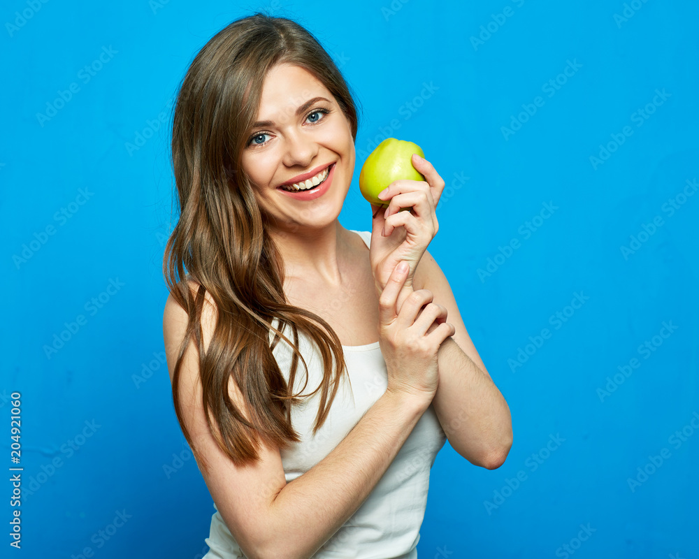 Young woman with healthy smile holding green apple. Young woman with healthy smile holding green apple.