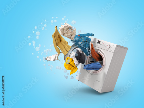 Photo Washing machine and flying clothes on blue background