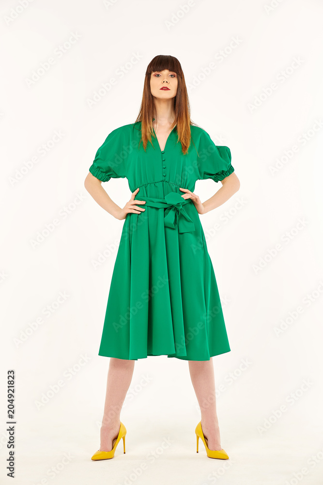 young girl standing in green dress young girl standing in green dress