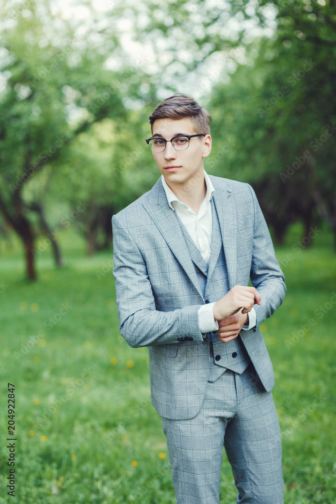 Elegnat groom at wedding suit and glasses smiling and waiting for bride. Young groom at wedding day. Elegnat groom at wedding suit and glasses smiling and waiting for bride. Young groom at wedding day.