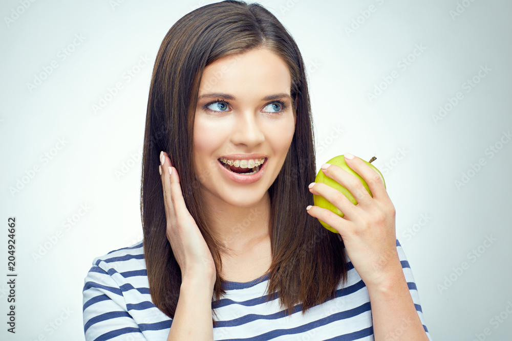 Teenager girl open mouth with dental braces on teeth holding gre Teenager girl open mouth with dental braces on teeth holding gre