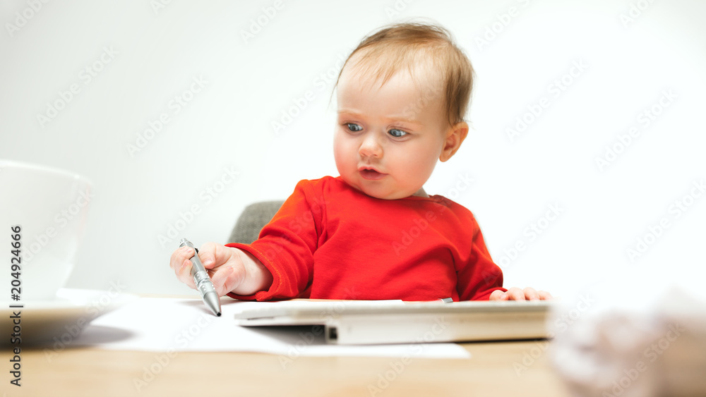 Happy child baby girl toddler sitting with keyboard of computer isolated on a white background Happy child baby girl toddler sitting with keyboard of computer isolated on a white background