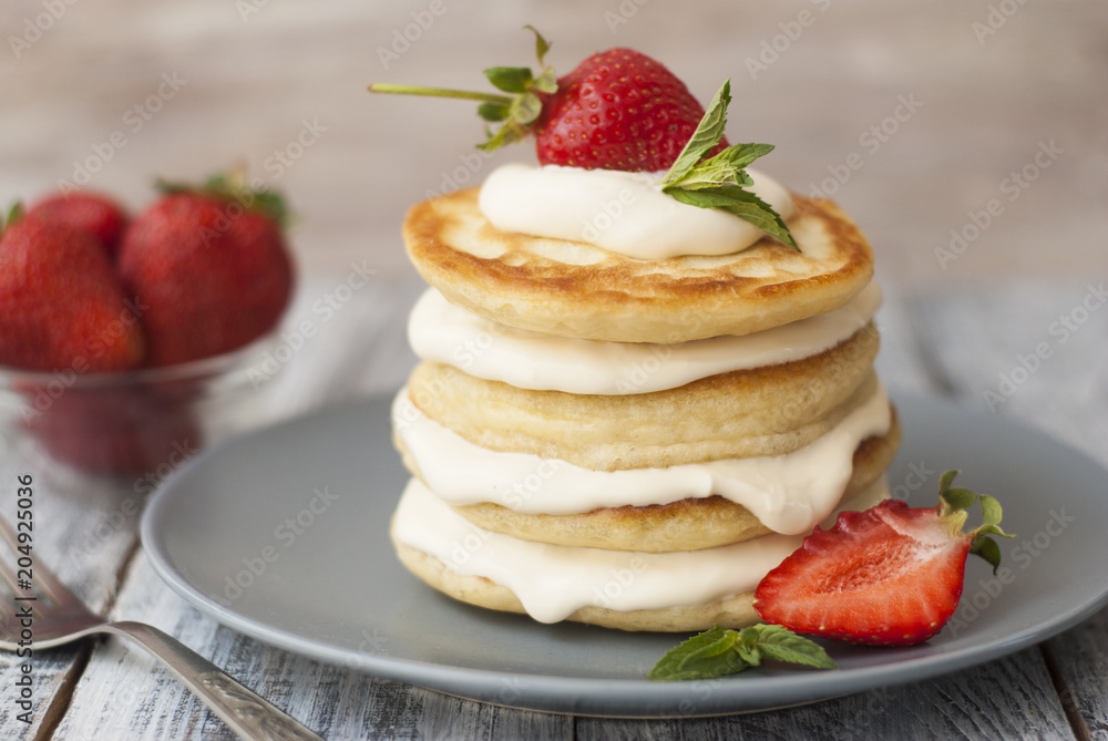 Sweet Pancakes with Cream and Strawbery. Health Breakfast Fruit Berry Vitamine Gray Rustic Wooden Background Sweet Pancakes with Cream and Strawbery. Health Breakfast Fruit Berry Vitamine Gray Rustic Wooden Background