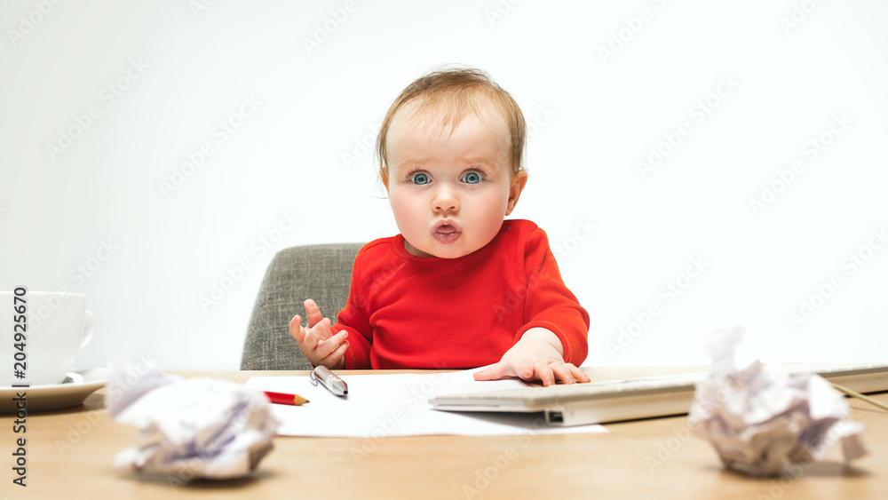 Happy child baby girl toddler sitting with keyboard of computer isolated on a white background Happy child baby girl toddler sitting with keyboard of computer isolated on a white background