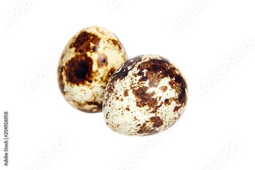 Two Quail spotted eggs, isolated on a white background