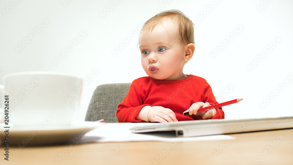 Happy child baby girl toddler sitting with keyboard of computer isolated on a white background Happy child baby girl toddler sitting with keyboard of computer isolated on a white background