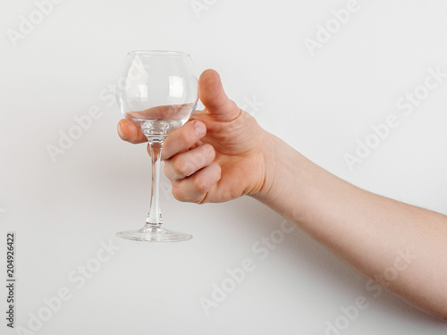 empty glass in hand on white background