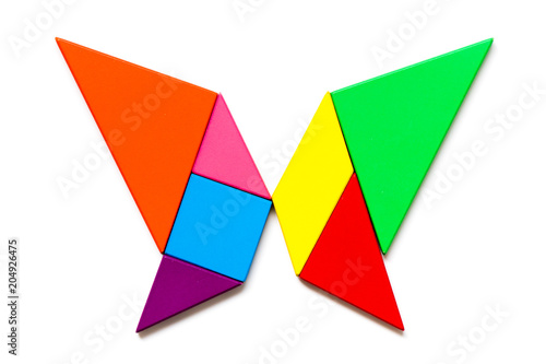 Color wood tangram puzzle in butterfly shape on white background