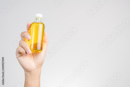 Hand holding  Thai Boxing Liniment or Namman Muay
