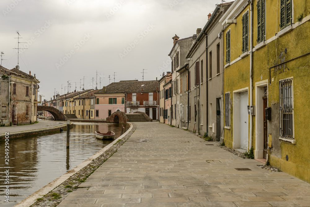 canal and embankment in san Pietro street, Comacchio, Italy