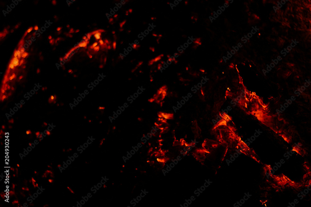 Smoldering coals on a black background Smoldering coals on a black background