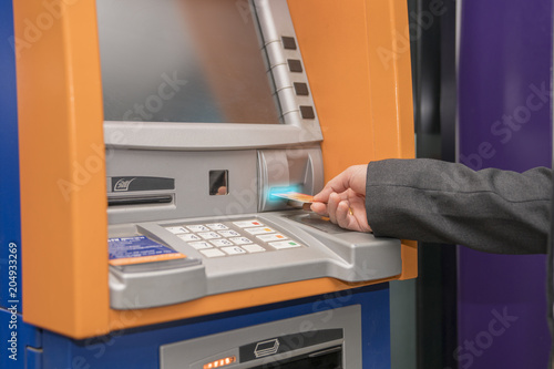 Woman hand used ATM card or credit card for withdraw money from ATM machine.