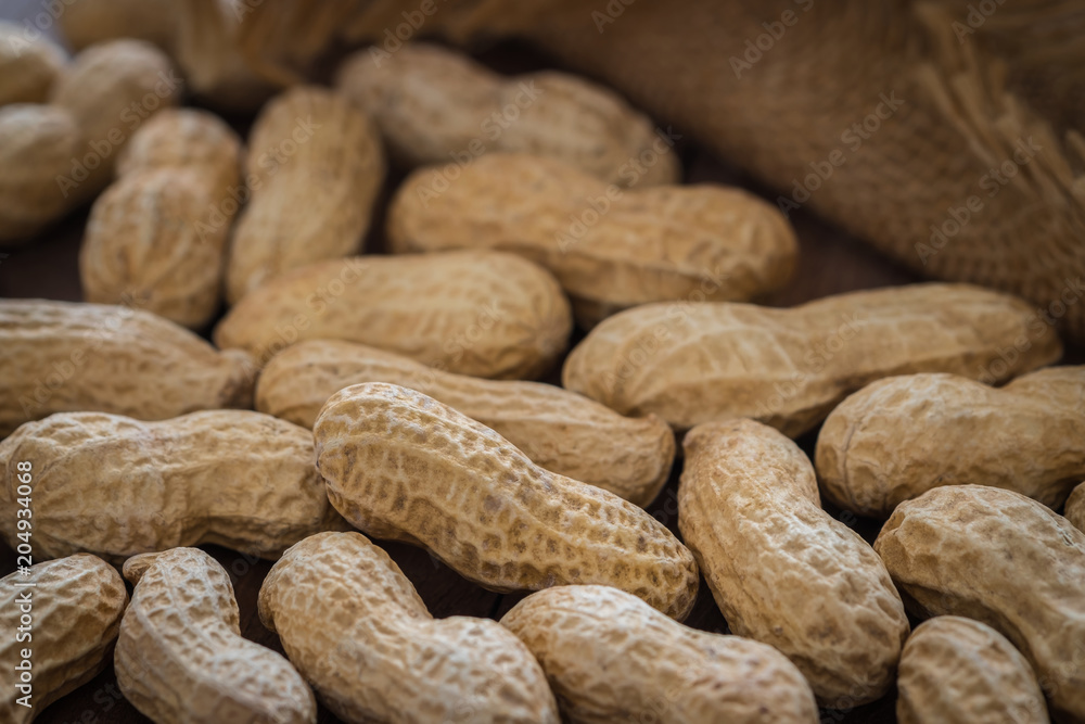 Roasted peanuts on wooden table Roasted peanuts on wooden table