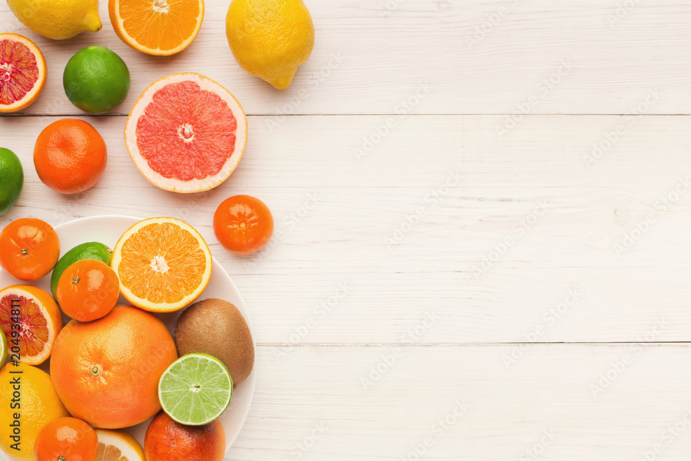 Platter of assorted citrus fruits on white wooden planks, top view Platter of assorted citrus fruits on white wooden planks, top view