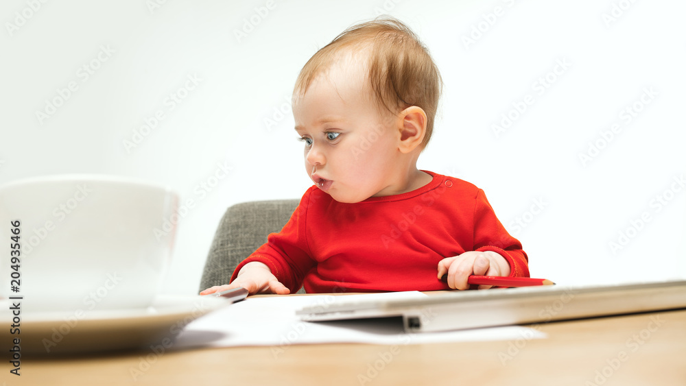 Happy child baby girl toddler sitting with keyboard of computer isolated on a white background Happy child baby girl toddler sitting with keyboard of computer isolated on a white background
