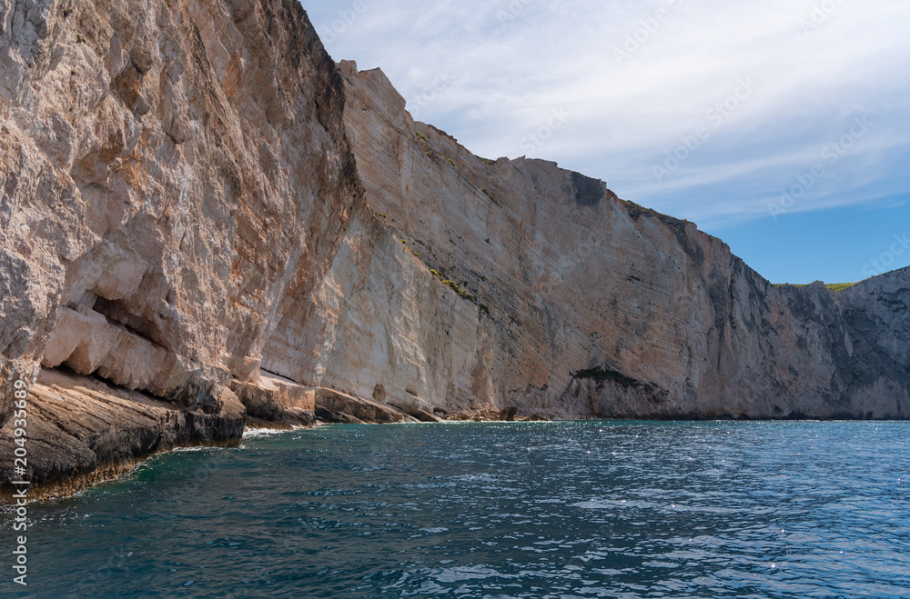 Fototapeta premium Blue Caves and blue water of Ionian sea on Island Zakynthos in Greece and sightseeing points. Rocks in clear blue sea