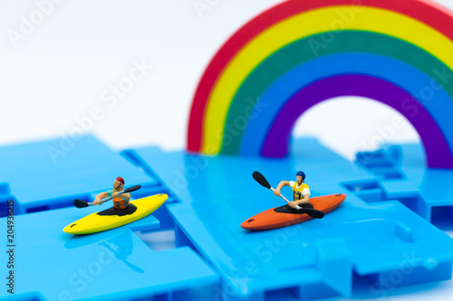 Miniature people : Tourist ride Kayaking along the rainbow. Image use for travel concept.