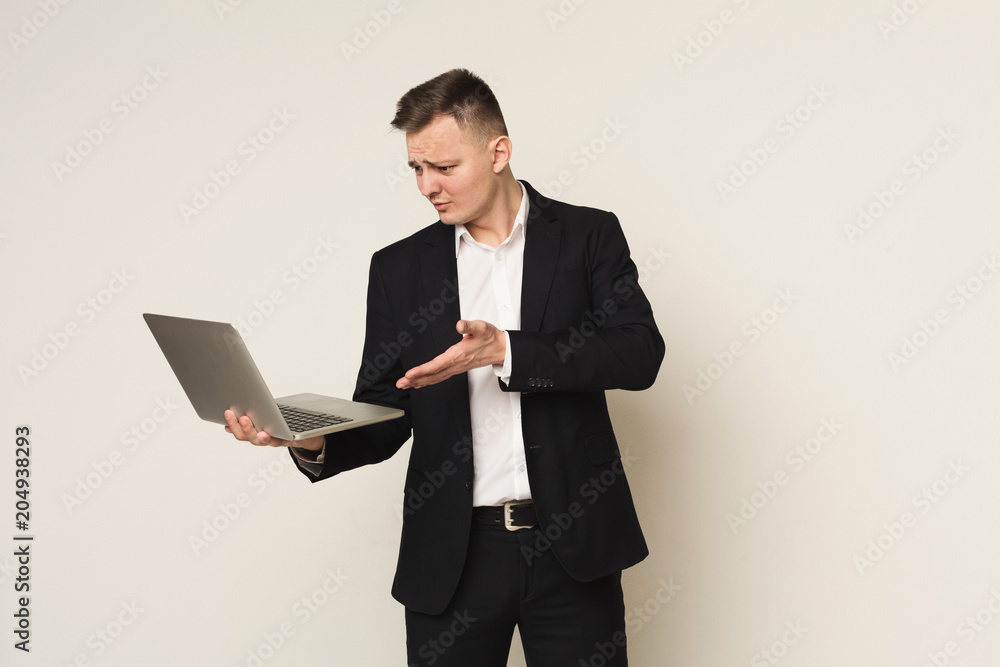 Disappointed caucasian businessman using laptop Disappointed caucasian businessman using laptop