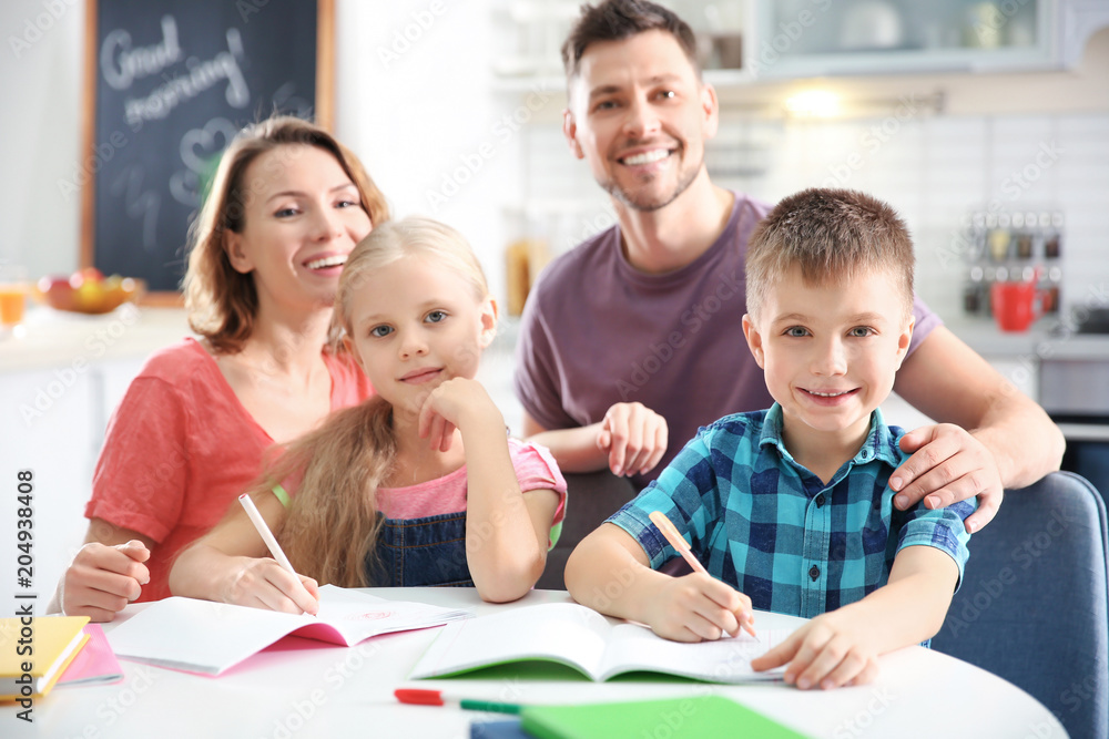 Little children with parents doing homework at home Little children with parents doing homework at home