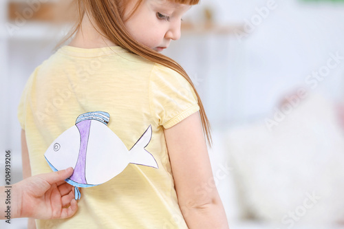Little boy sticking paper f...