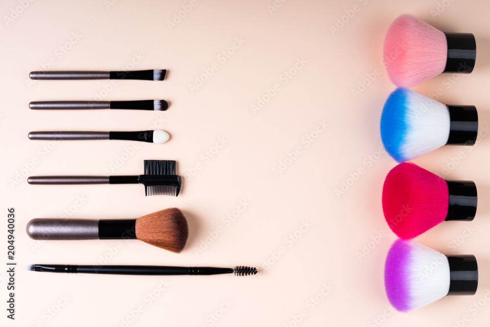 Cosmetics accessories for makeup on beige background flat lay. Set of cosmetics brushes. Minimal composition. Fashion and beauty blogging concept. Top view, copy space Cosmetics accessories for makeup on beige background flat lay. Set of cosmetics brushes. Minimal composition. Fashion and beauty blogging concept. Top view, copy space
