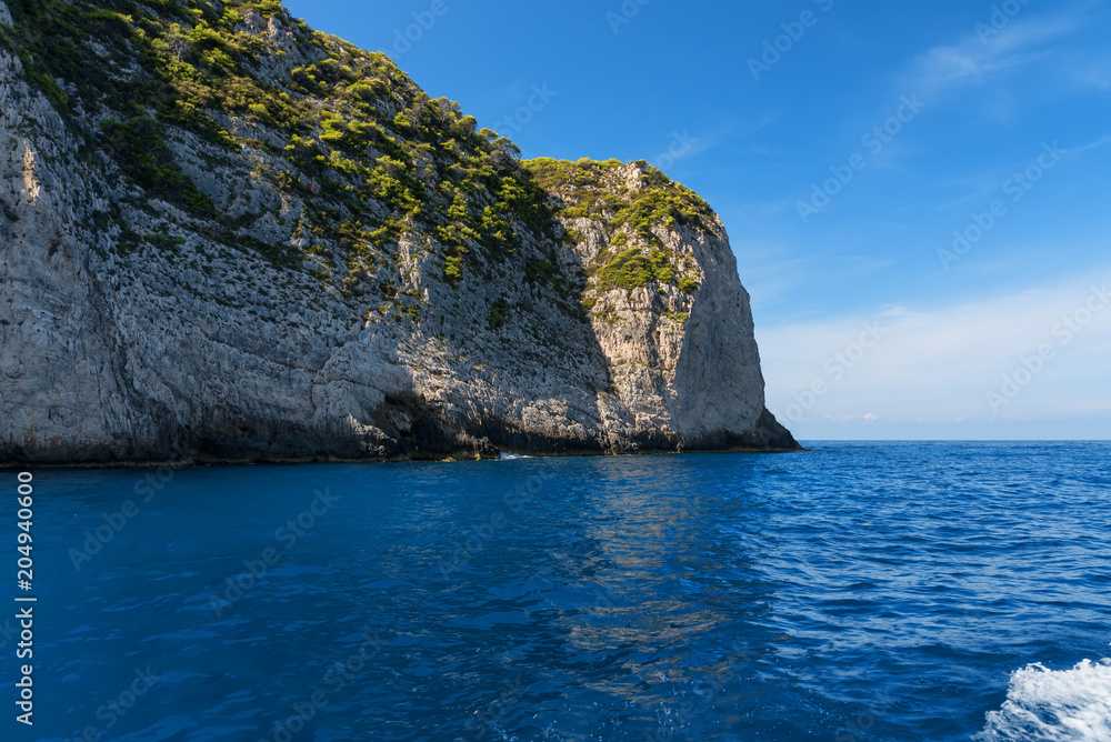 Blue Caves and blue water of Ionian sea on Island Zakynthos in Greece and sightseeing points. Rocks in clear blue sea