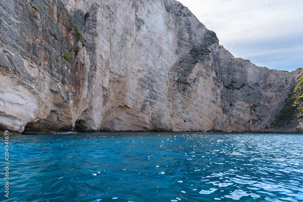 Blue Caves and blue water of Ionian sea on Island Zakynthos in Greece and sightseeing points. Rocks in clear blue sea