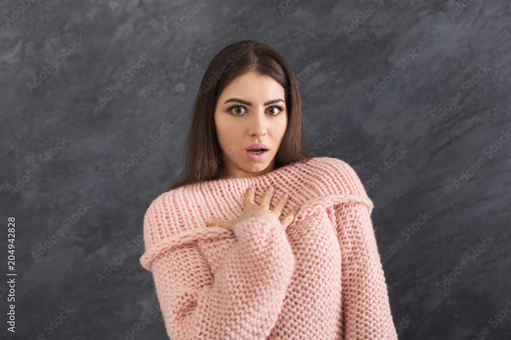 Shocked woman on grey background Shocked woman on grey background