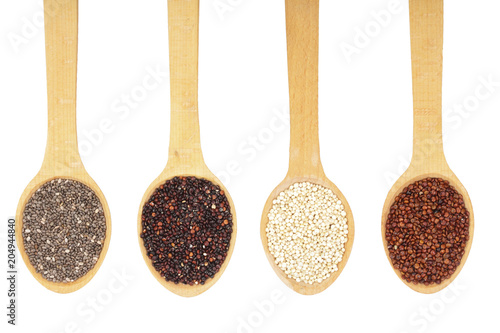 Black red white quinoa and chia seeds in wooden spoon isolated on white background. Top view