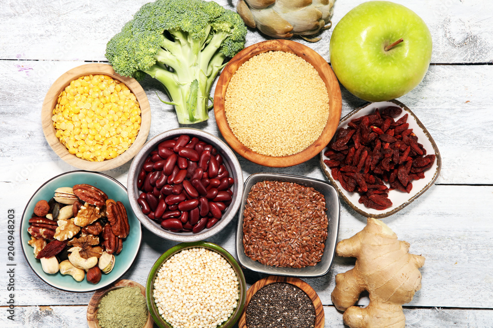 superfood concept on white table with avocado, goji and nuts and seeds. superfood concept on white table with avocado, goji and nuts and seeds.