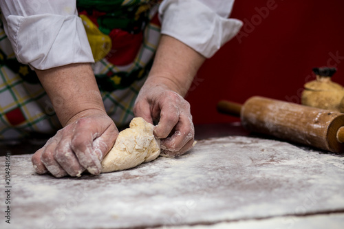 Female hands making dough for pizza. Making bread. Cooking Process Concept