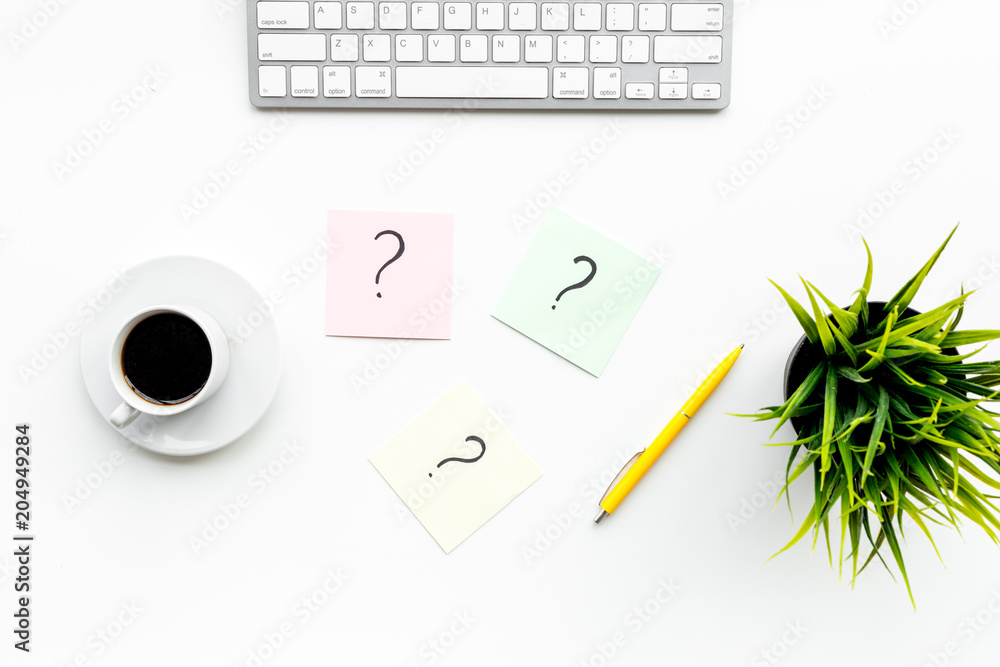 Question mark on sticky notes on office desk on white background top view. FAQ concept. Working with clients. Troubles in work. Question mark on sticky notes on office desk on white background top view. FAQ concept. Working with clients. Troubles in work.