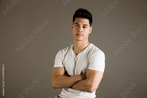 Young man sitting on chair in studio photo