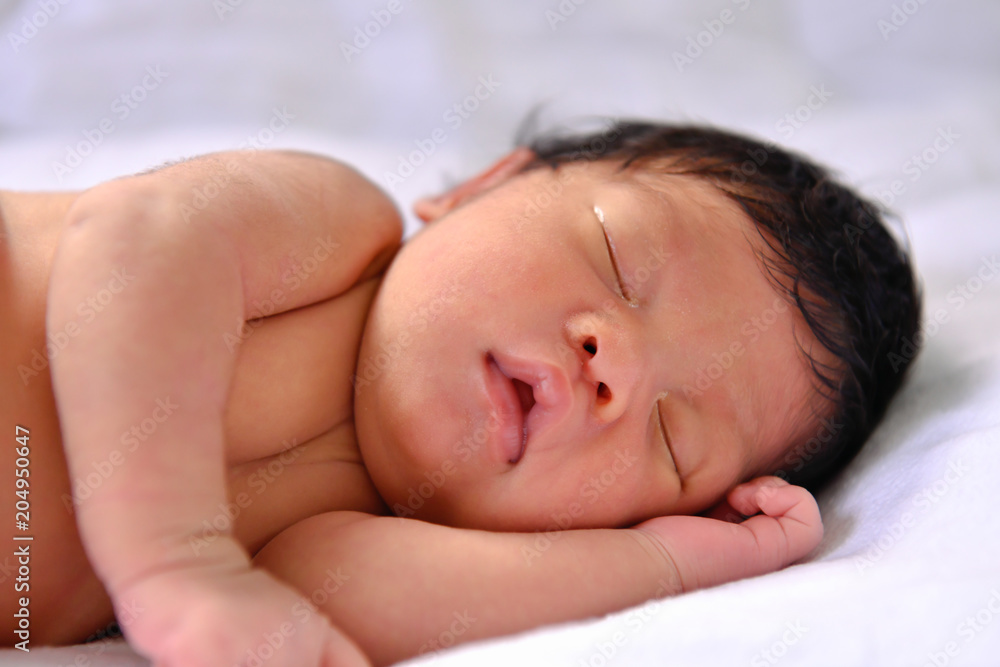 Newborn Concept. Newborn babies are sleeping in a bed. The baby is in the white bedroom. Newborn Concept. Newborn babies are sleeping in a bed. The baby is in the white bedroom.