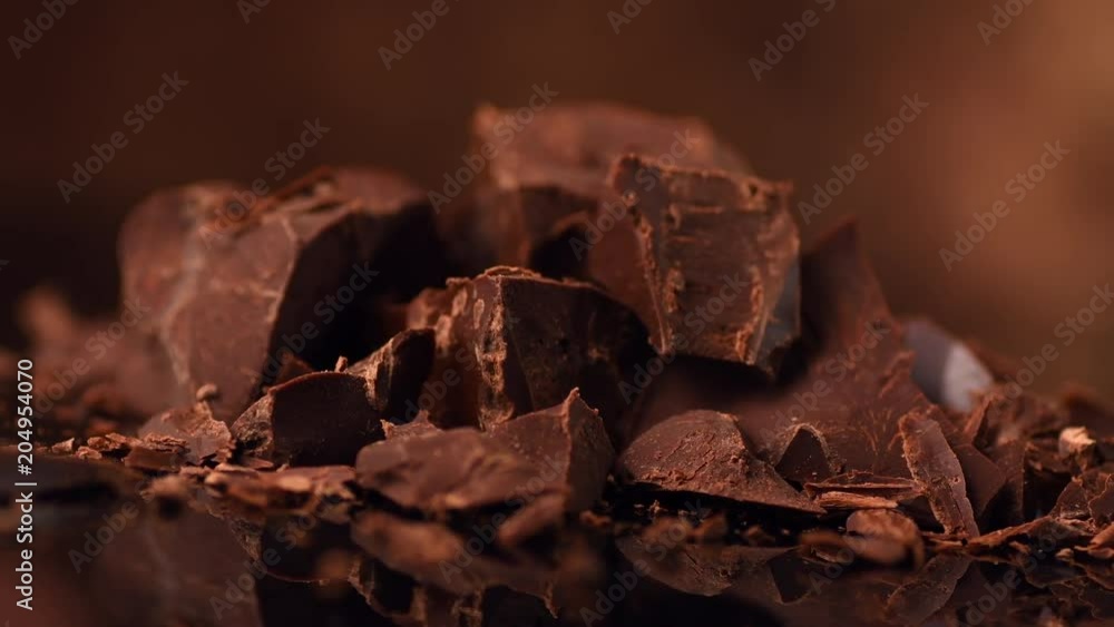 Chocolate. Chunks of sweet dark chocolate rotated closeup. Dessert ingredient. Confectionery. Slow motion 4K UHD video 3840X2160 Chocolate. Chunks of sweet dark chocolate rotated closeup. Dessert ingredient. Confectionery. Slow motion 4K UHD video 3840X2160
