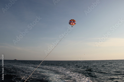 A man and a girl are flying on a parachute.
