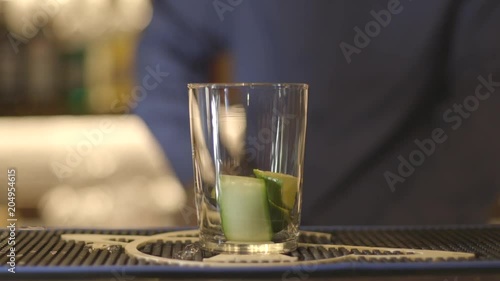 Close up, bartender uses cocktail muddler photo
