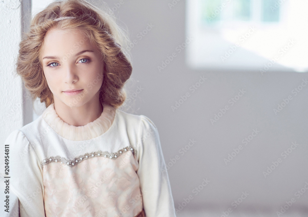 Charming little girl model posing in a studio. Charming little girl model posing in a studio.