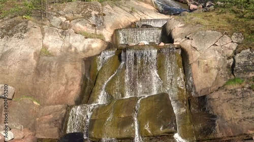 Waterfall Putouskallio in Sapokka water Park on a Sunny summer day. Kotka, Finland   photo