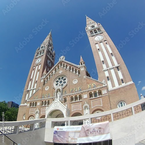 The Votive Church and Cathedral of Our Lady of Hungary is a twin-spired roman catholic cathedral in Szeged, Hungary. It lies on Dom Ter square beside the Domotor tower. photo